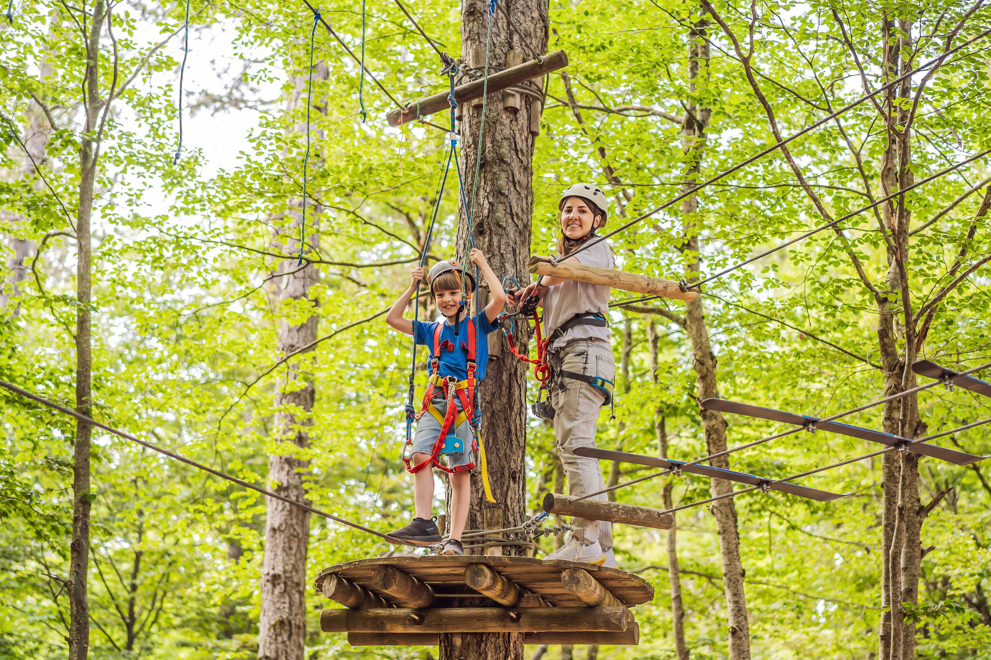 Мама с сыном проходят маршрут в веревочном парке. Источник: Shutterstock